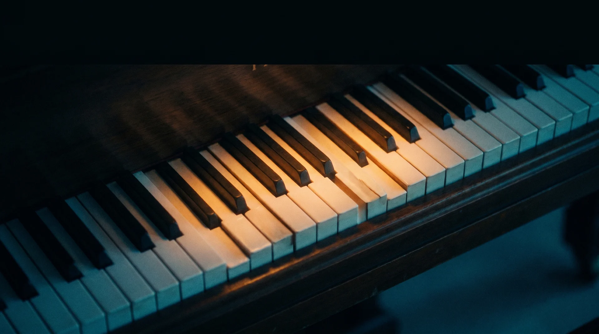 old black piano with some broken keys